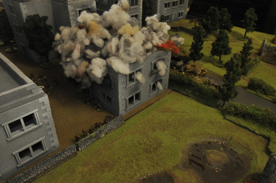 German forces from KG Von Tettau advance under fire into Arnhem past a destroyed building, whilst a section of 2nd Para watch from behind their stone wall defensive position.